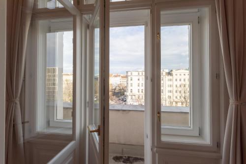 a room with two windows and a view of a city at BOUTIQUE RESIDENCES at GAUDENZDORFER in Vienna