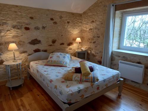 a small bedroom with a bed and a window at Gîte des Champs Lalaurie in Sauveterre-la-Lémance