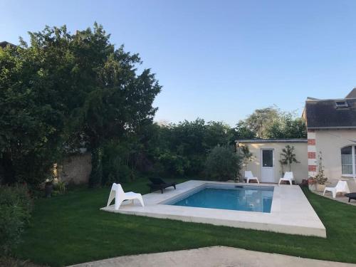 a swimming pool in the yard of a house at maisonette cosy Blois in Blois