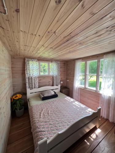 a bedroom with a large bed in a wooden room at Aadniel's Holiday Village in Aula