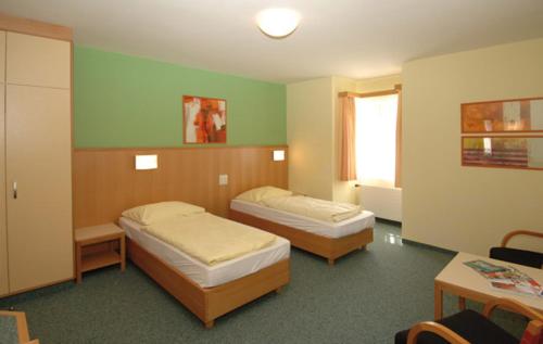 Tempat tidur dalam kamar di Austrian Sports Resort, BSFZ Obertraun