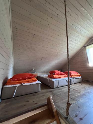 two beds in a room with a roof at Aadniel's Holiday Village in Aula