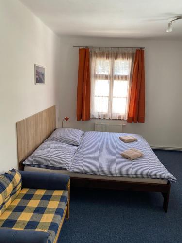 a bedroom with two beds and a window at Pension Bystřenka in Špindlerův Mlýn