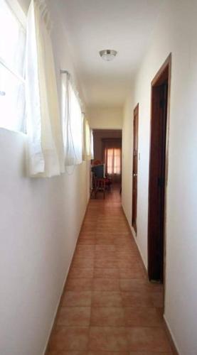 a hallway of a room with white walls and a tile floor at Amplio y acogedor -2D 1B in Tuxpan de Rodríguez Cano