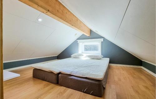 a bedroom with a bed in a attic at 2 Bedroom Stunning Apartment In Skrhamn in Klövedal
