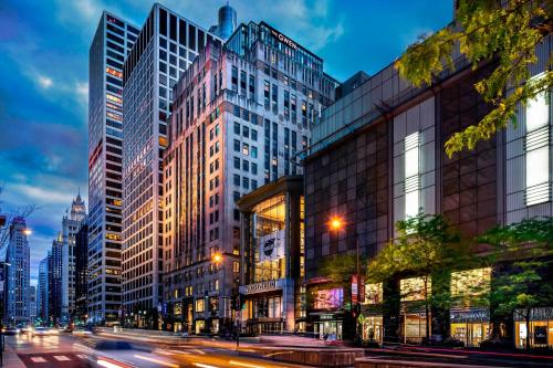 a busy city street with tall buildings and traffic at The Gwen, a Luxury Collection Hotel, Michigan Avenue Chicago in Chicago