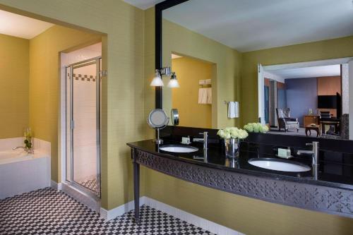 a bathroom with two sinks and a large mirror at Hotel Chicago Downtown, Autograph Collection in Chicago