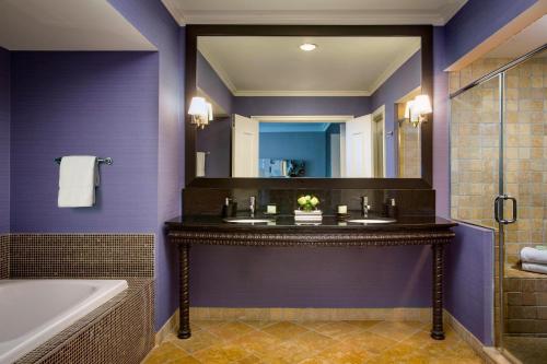 a bathroom with purple walls and a tub and a sink at Hotel Chicago Downtown, Autograph Collection in Chicago