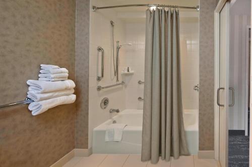 a bathroom with a tub and a shower with towels at Hartford Marriott Downtown in Hartford