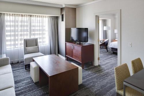 a hotel room with a television and a living room at Hartford Marriott Downtown in Hartford