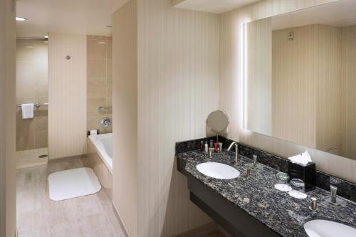 a bathroom with two sinks and a large mirror at Hartford Marriott Downtown in Hartford