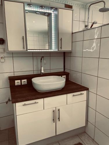 a bathroom with a sink and a mirror at Appartement Sabrina in Steinberg am Rofan