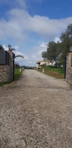 an empty road with a building on the side at sunset house in Vitalades