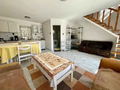 a living room with a couch and a table at Györe Vendégház Galambok in Galambok