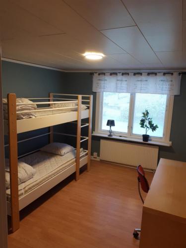 a room with two bunk beds and a window at Brofors in Forsheda