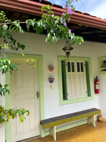 a house with a bench in front of it at Chalés Lavras de Minas - Brasil in Lavras Novas