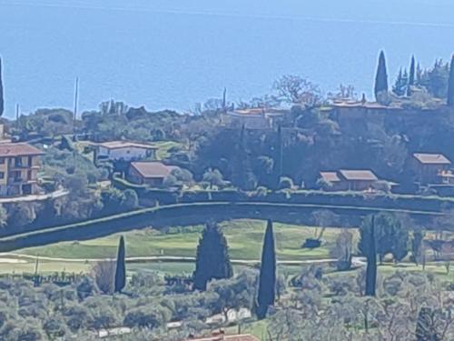 a bridge over a park with trees and houses at Agriturismo L'Uliveto in Gargnano