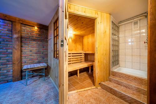 a sauna with wooden walls and stairs in a house at Krasne Domki in Krasnobród
