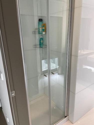 a shower with a glass door in a bathroom at Fuzeta stylish 1 bedroom apartment - Amazing views in Fuzeta