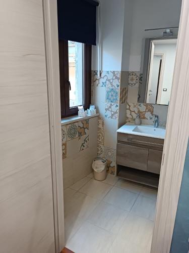 a bathroom with a sink and a toilet at La casa in piazzetta in Enna