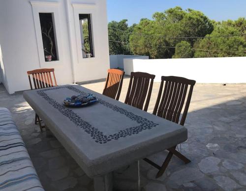 a table and chairs on a patio with a table at Semini Villa in Kalymnos