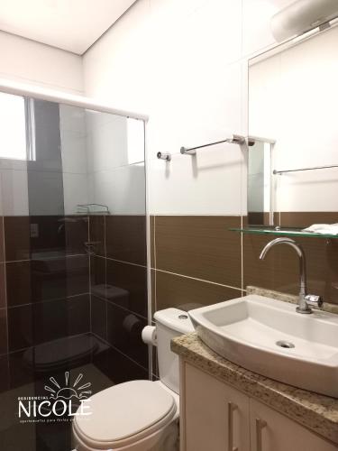 a bathroom with a toilet and a sink at Residencial Nicole in Florianópolis