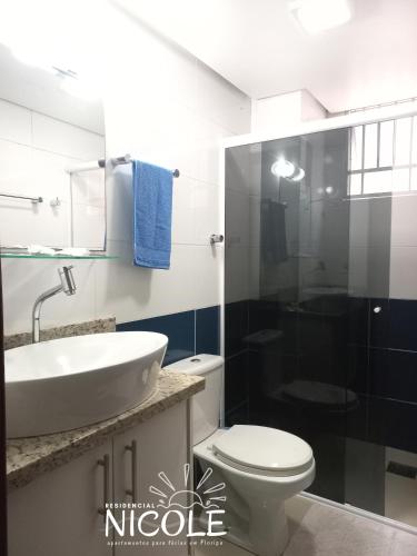 a bathroom with a sink and a toilet and a shower at Residencial Nicole in Florianópolis