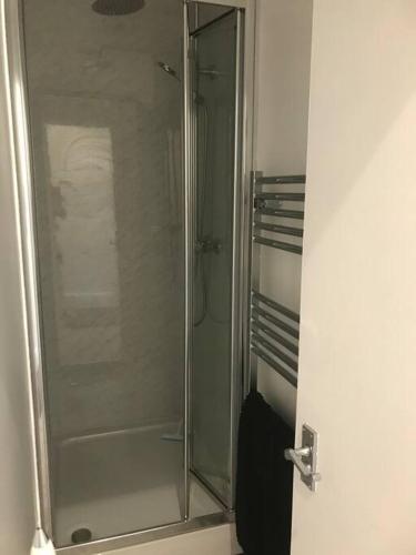 a shower with a glass door in a bathroom at Myrtle villa 10 bedrooms sleeps 28, 2 min to beach in Weymouth