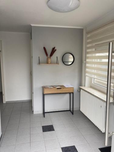 a room with a table and a mirror on the wall at Appartment Griesheim in Griesheim