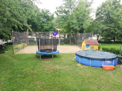 a playground with a trampoline in the grass at TOBO house along the river Danube in Radvaň nad Dunajom