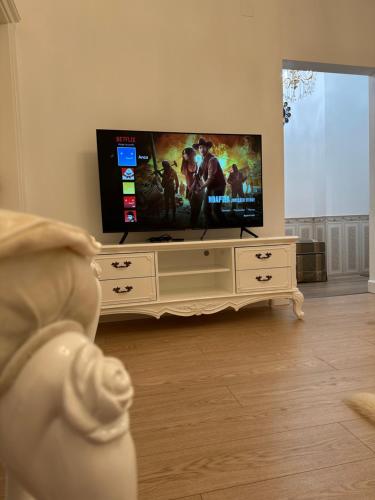 a living room with a flat screen tv on a entertainment center at FSF Boutique Apartament in Timişoara