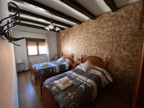 En eller flere senger på et rom på Casa rural Mis Angelitos Lezuza