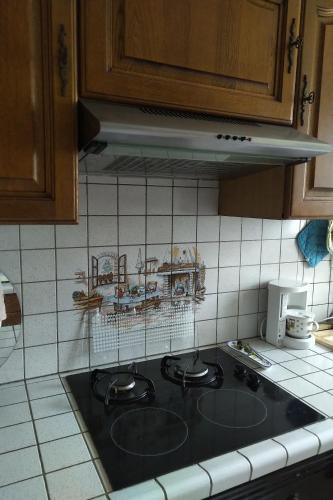 a kitchen counter with a stove top in a kitchen at Chambre 5 minutes de la gare à pieds in Les Mureaux