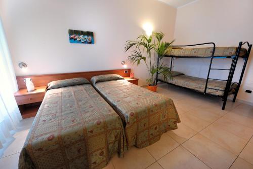 a bedroom with two beds and a bunk bed at Hotel Arma Ristorante in Arma di Taggia