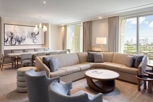 a living room with a couch and a dining room at JW Marriott Miami Turnberry Resort & Spa in Aventura