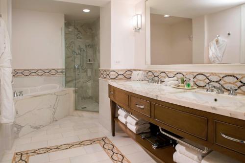 a bathroom with a sink and a shower and a tub at JW Marriott Miami Turnberry Resort & Spa in Aventura