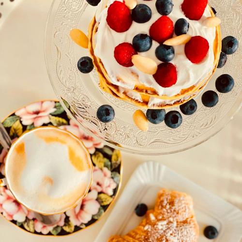a cake with fruit on top on a plate at FUTURA ROOM&RELAX in Termoli