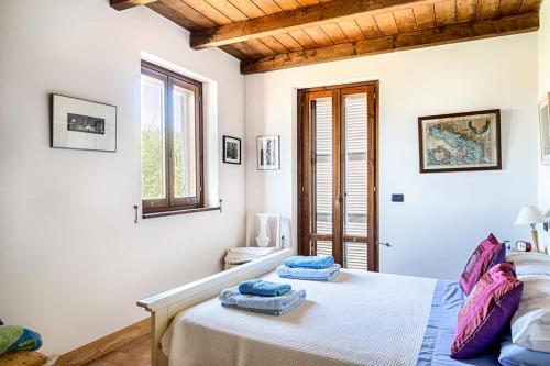 a bedroom with a bed with two towels on it at Casa Vitale in Carassai