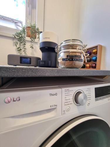 a white washing machine with a counter on top of it at BaMo Studio - modern living lakeside in Klagenfurt