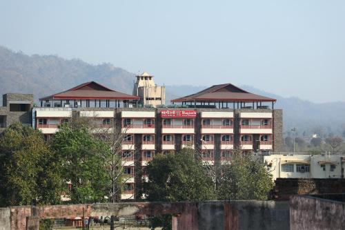 a large white building with a tower on top of it at Perfectstayz Premium @Harkipauri Road in Haridwār
