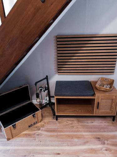 a room with a bed and a bench in a attic at Ferienhaus zur Weinfee in Briedel