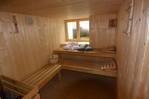 a wooden sauna with a bench and a window at Haus Erli in Mittenwald