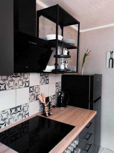 a kitchen with black cabinets and a wooden counter top at Ferienhaus zur Weinfee in Briedel