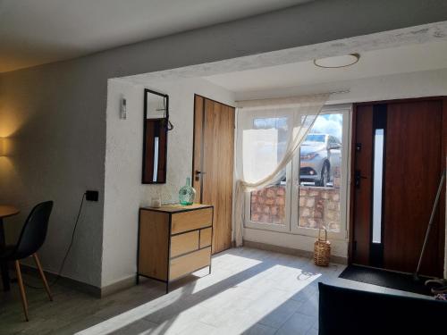 a living room with a dresser and a door with a window at Apartament Nova Kamienica - Studio in Łagów