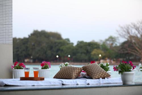 a table with two pillows and flowers on it at Perfectstayz Premium @Harkipauri Road in Haridwār