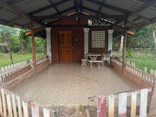a porch of a house with a table and chairs at Hillmyna garden home stay in Ko Por