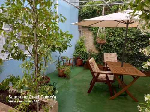 a patio with an umbrella and a table and chairs at Room in Nerezine with balcony, Wifi 4827-5 in Nerezine