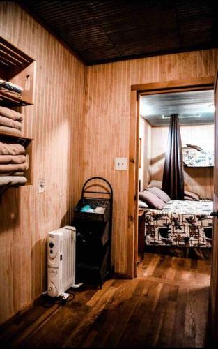 a room with a bedroom with a bed and a fan at Liberty Cabin on Collier Creek in Norman