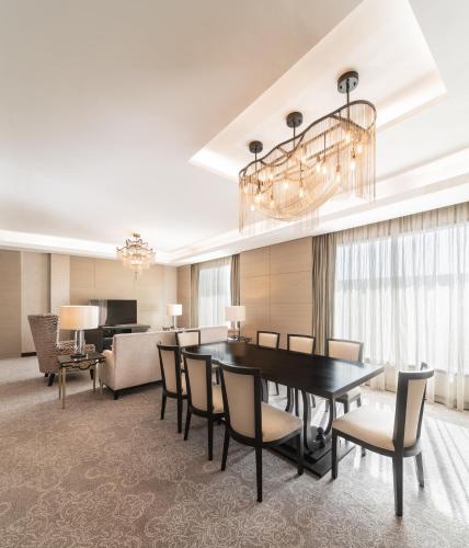 a dining room with a table and chairs at Radisson Collection Muscat, Hormuz Grand in Muscat