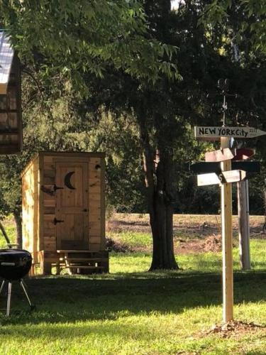 a new york street sign next to a shed at Caddo Cabin on Collier Creek in Norman